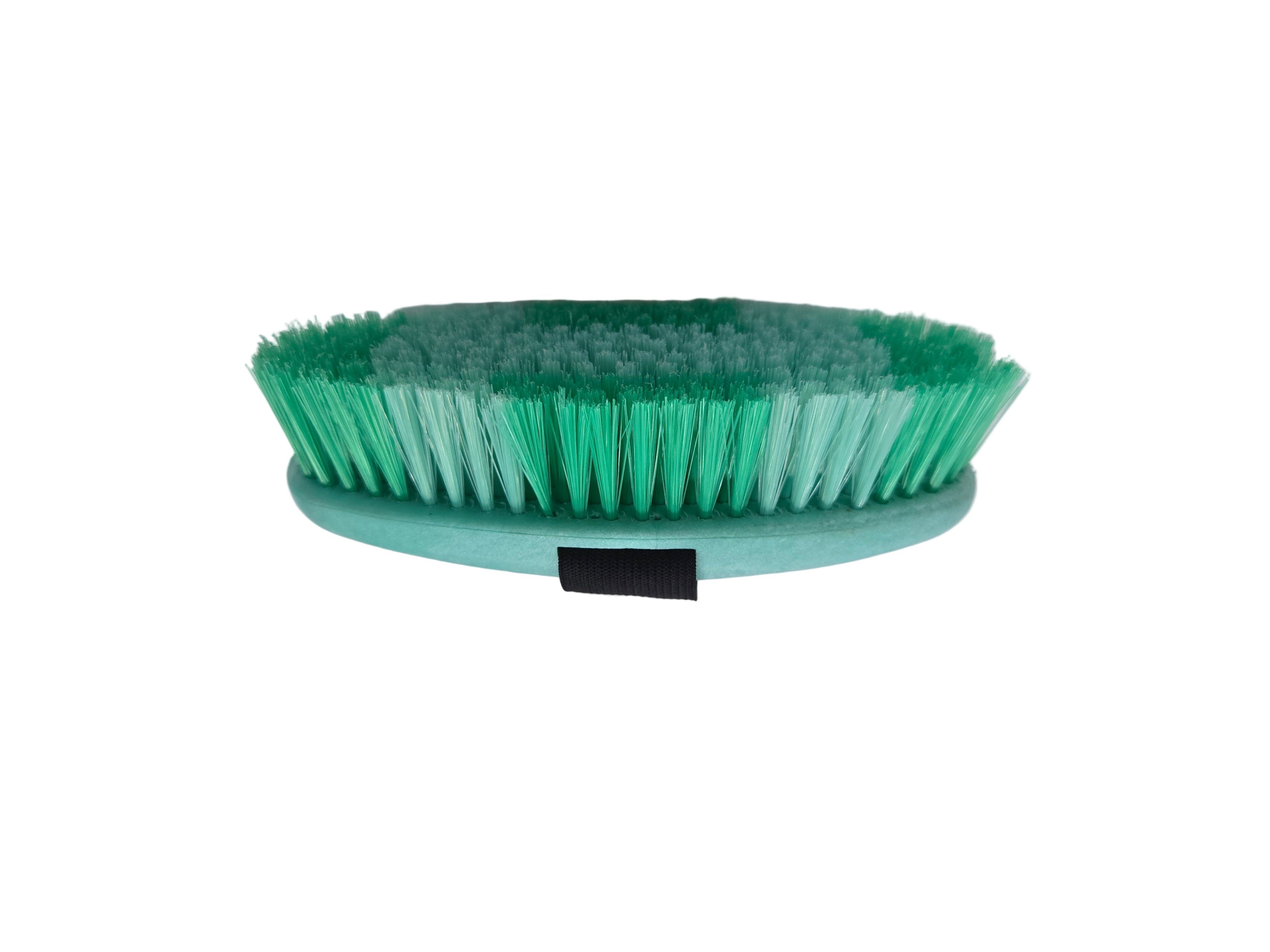 Green brush with a black handle on a white background